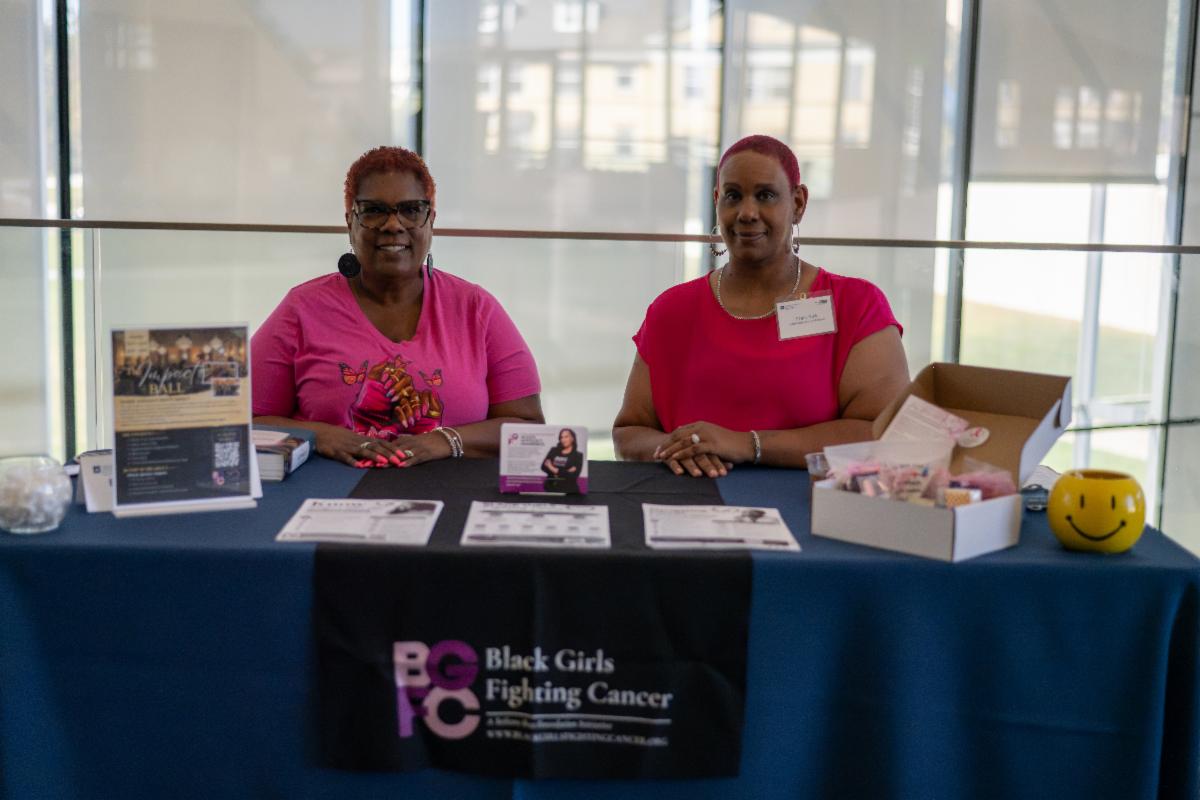 Representatives from Black Girls Fighting Cancer staff a community outreach table during the Case Comprehensive Cancer Center Annual Scientific Retreat.