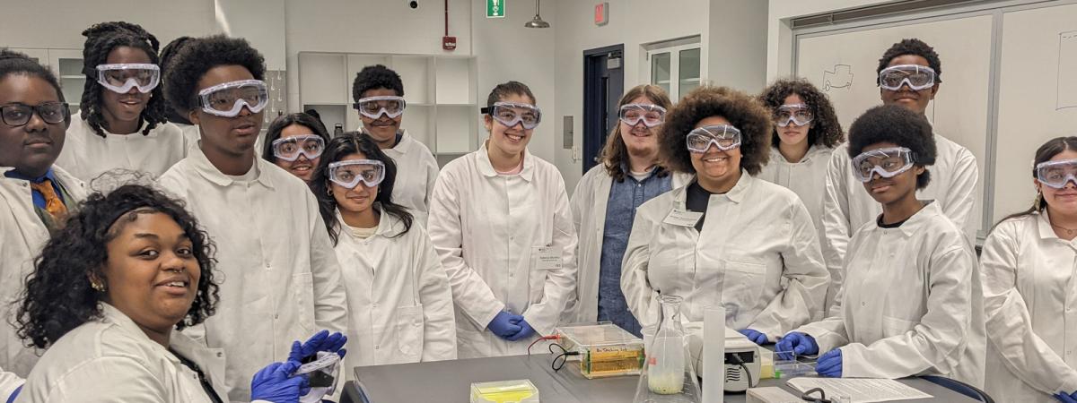 Students participating in a laboratory training experience while working together in a science classroom.