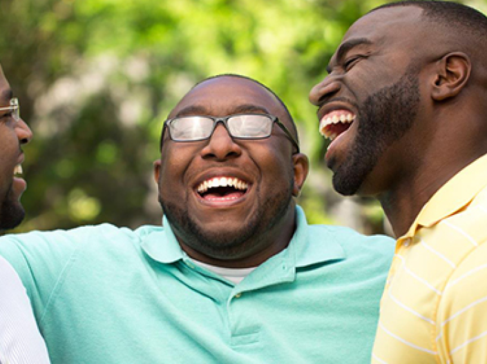 three African American men laughing together