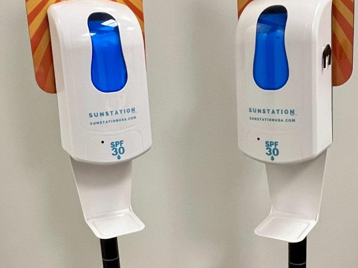 two sunscreen dispensers