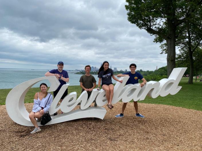 students sitting on Cleveland sign