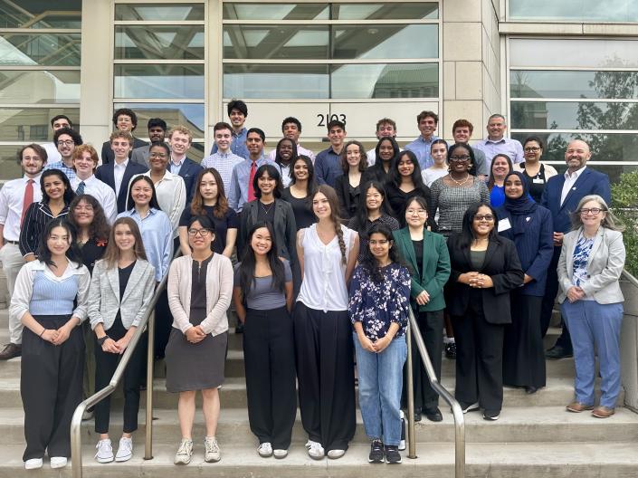 CanSUR 2025 cohort students standing together on the steps in front of the Wolstein Research Building