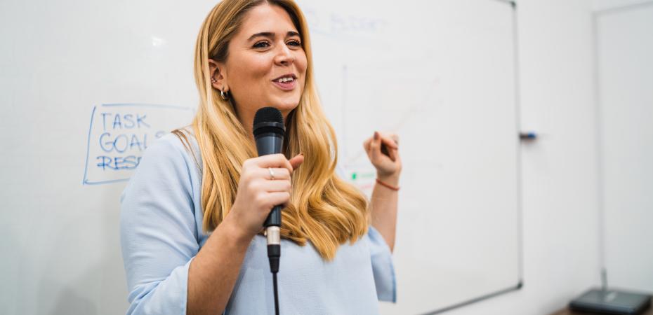 Woman holding a microphone and smiling