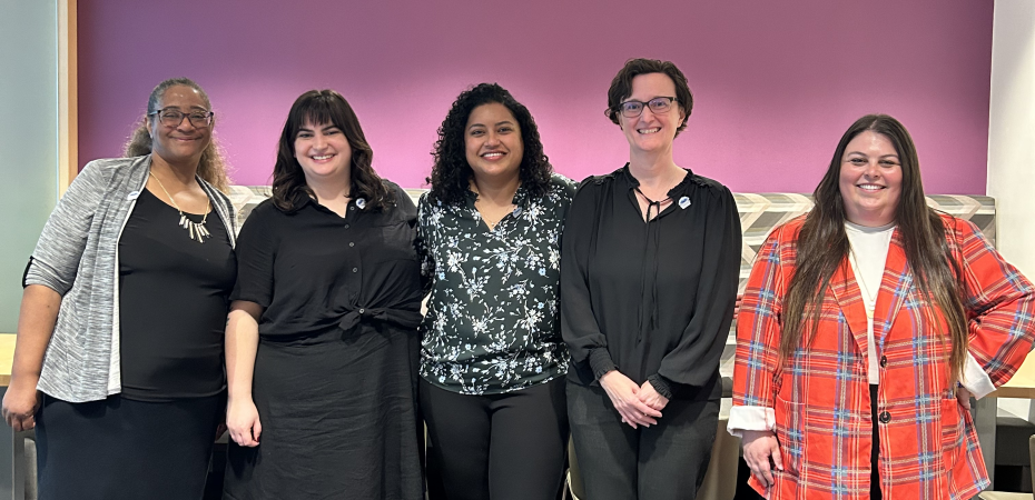 Five women stand side by side