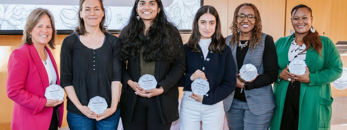 Six women standing side-by-side holding awards.