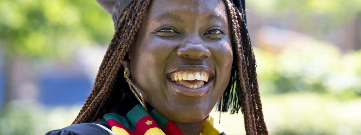 Picture of student with gap and gown on for graduation