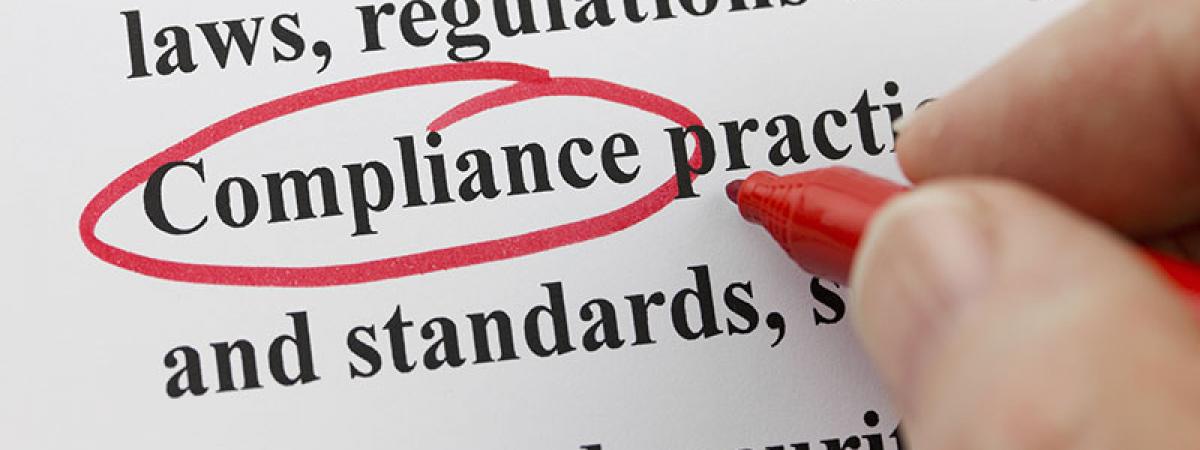Compliance word circled in red on a piece of paper with other text.