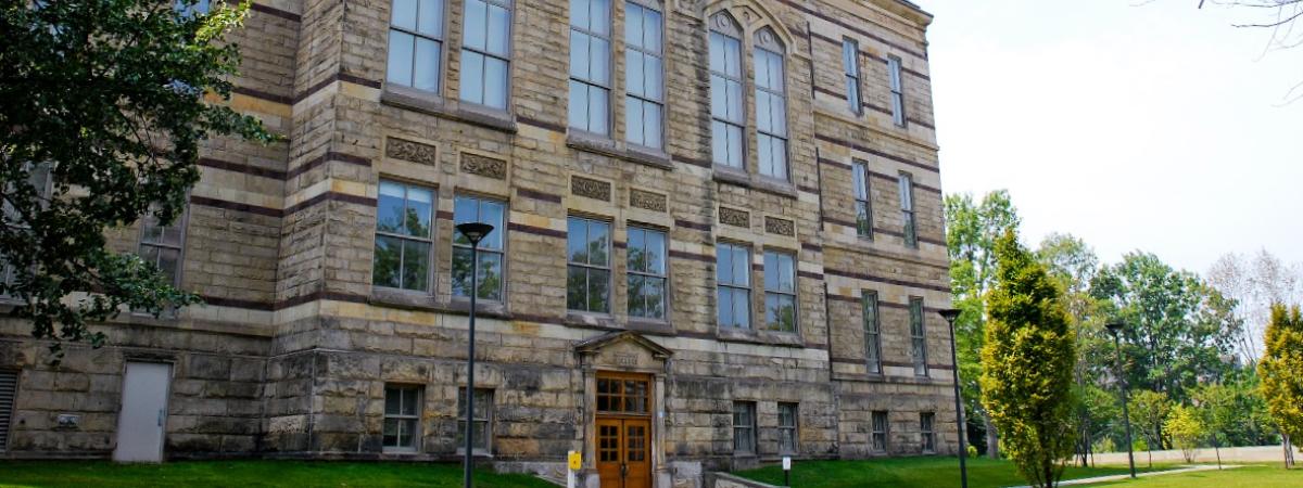 A large building with numerous windows, known as Adelbert Hall, showcasing its impressive architecture.