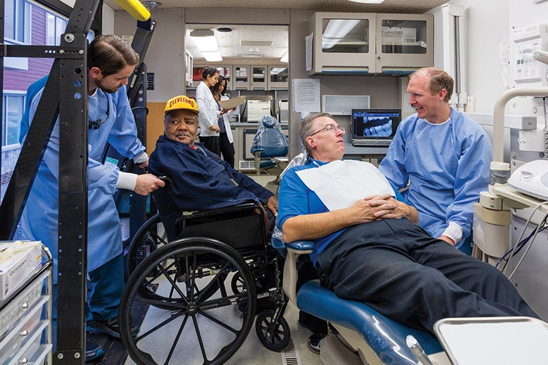 Picture of Dental Students and people from the community inside of the RV