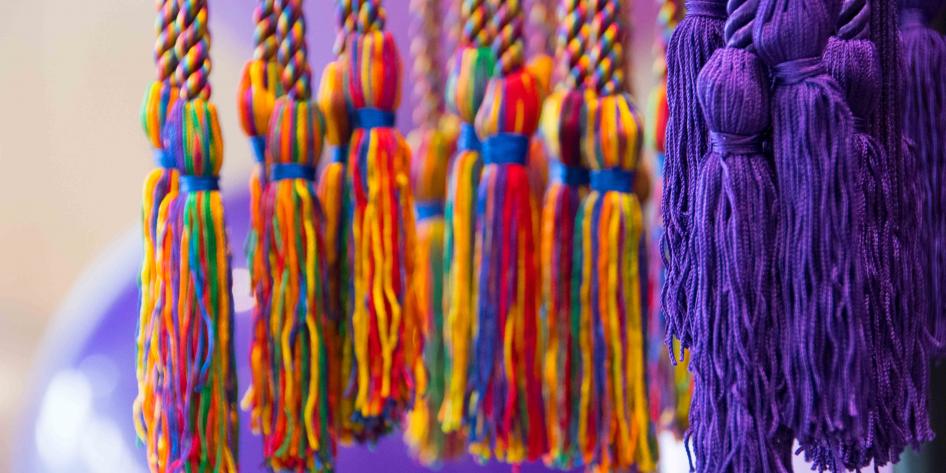 Close-up of rainbow and purple cord tassels