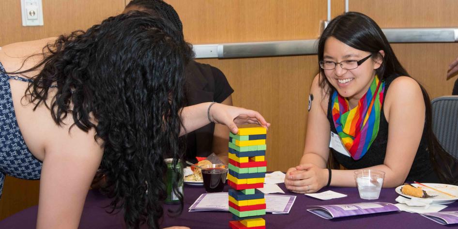 Students playing Jenga at Lavender Graduation