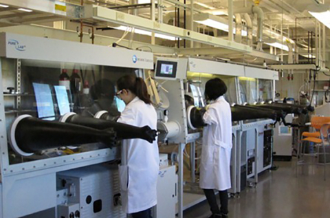 Researchers using glovebox