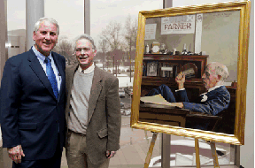Two men standing next to a painting 