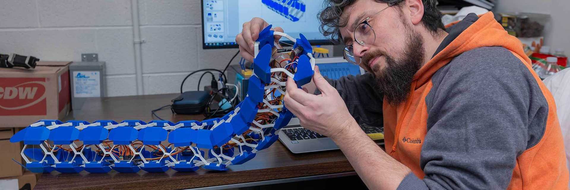 Photo of a Case Western Reserve University researcher working with machinery in an engineering lab
