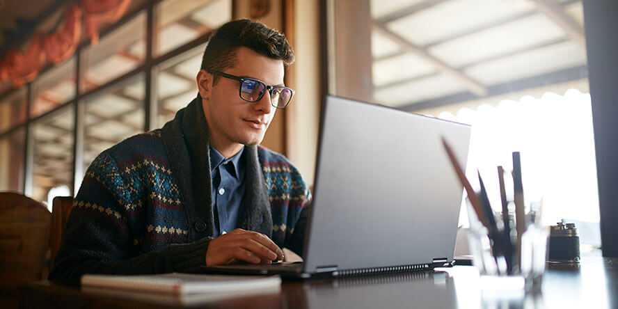 Photo of a person using a laptop in an office setting