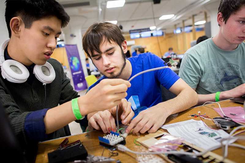 Photo of three Case Western Reserve University students working on a project in Sears think[box]