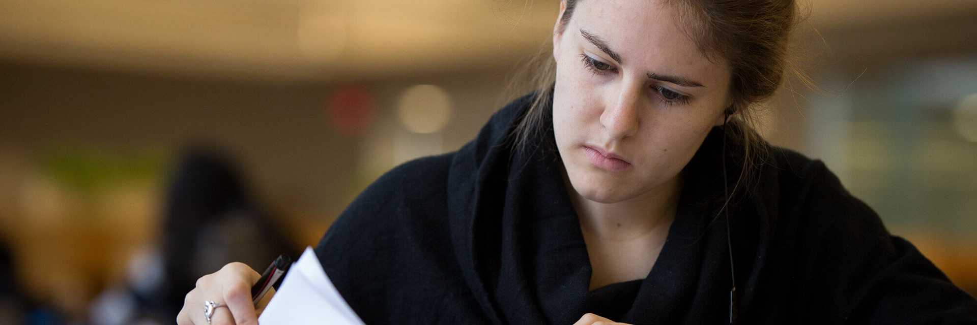 Close-up photo of a Case Western Reserve University student studying indoors