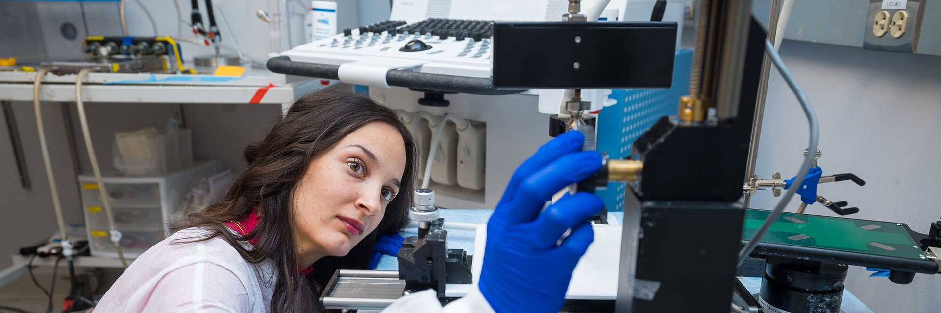 Photo of a Case Western Reserve University student and faculty member conducting engineering research together using a syringe