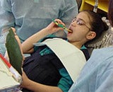 A young adult getting her teeth cleaned
