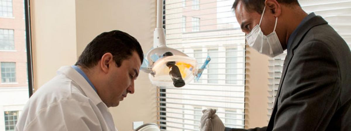 Two dentists examining a patient.