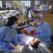 Two dentists inspecting a child