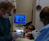 Two dentists inspecting a patient