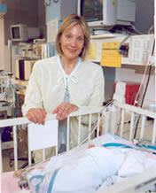 Lynn T. Singer Standing by a crib