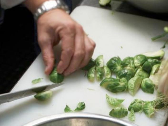 Person chopping food in the kitchen