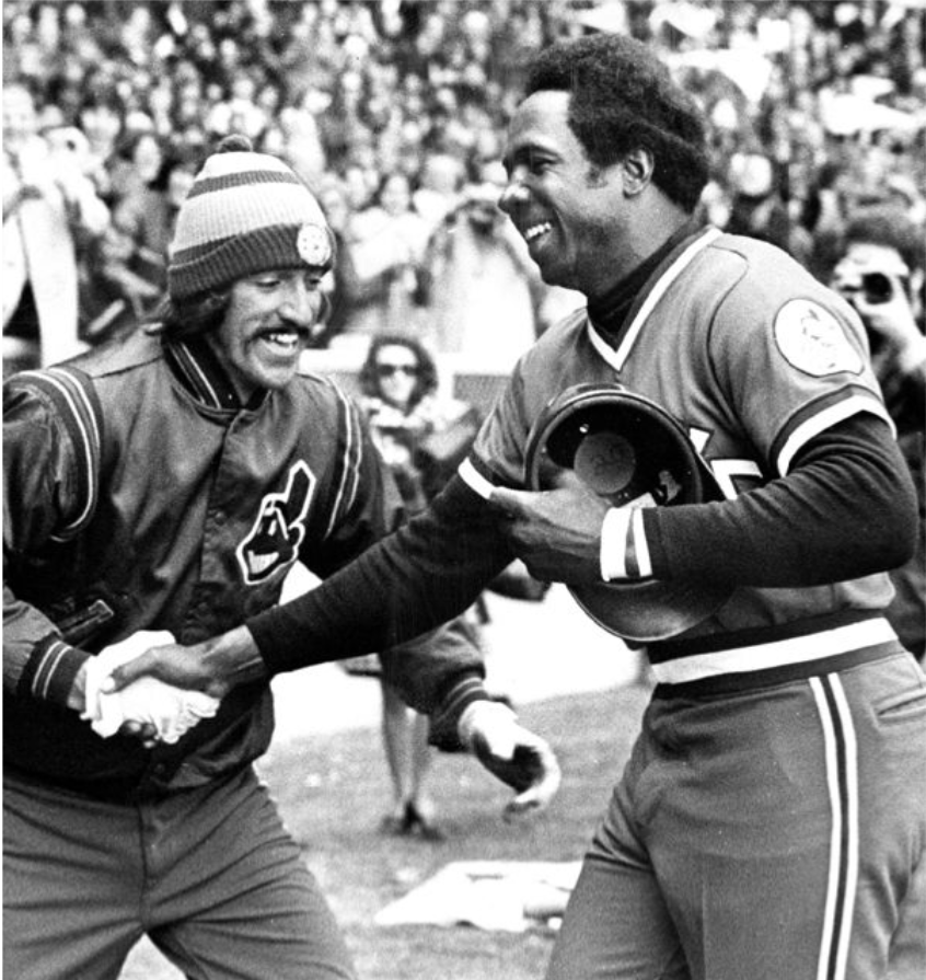 After homering in his first at-bat on Opening Day 1975, Cleveland Indians player/manager Frank Robinson is greeted by Tribe player John Lowenstein