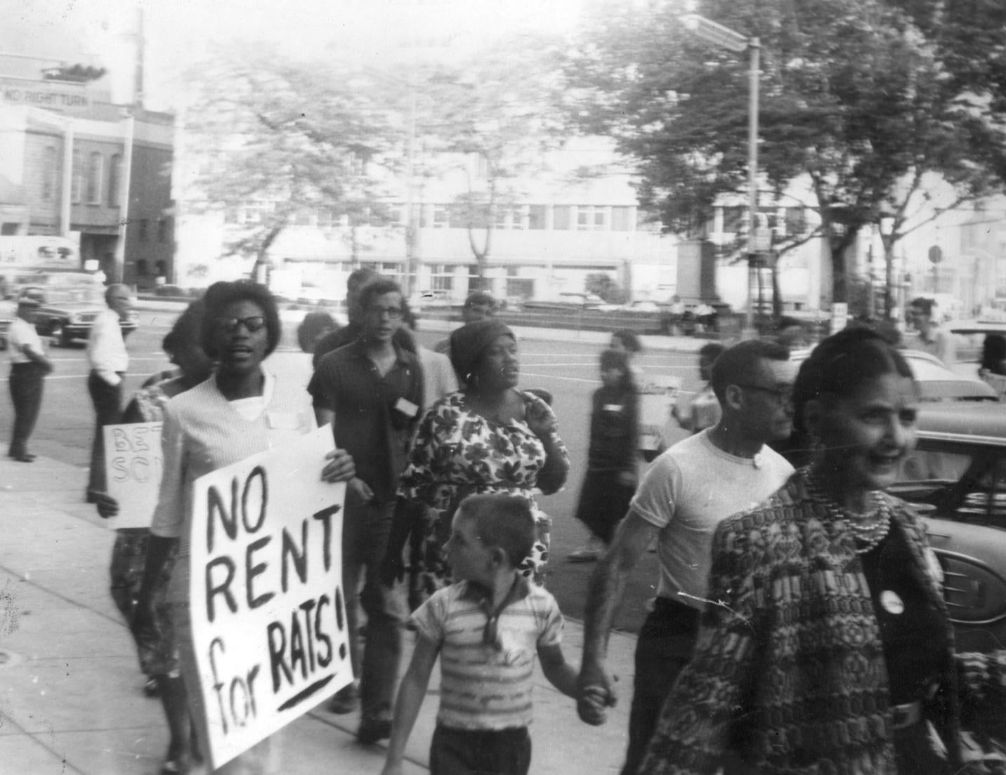 Poor women, mostly on welfare, marching in front of city hall, demanding better housing in 1965.