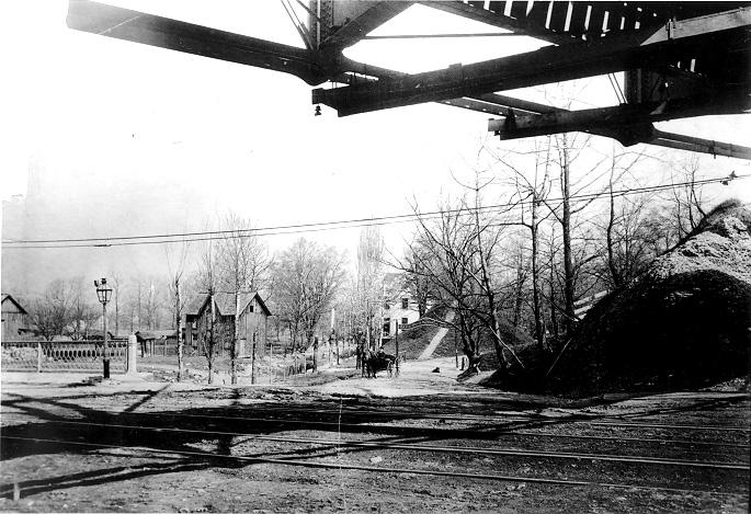 A carriage is exiting the Blue Rock Mineral Springs at the foot of Cedar Hill, ca. 1900. 