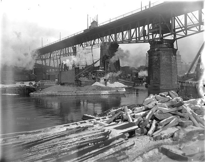 This view from the Cuyahoga River shows the swing span of the Central Viaduct circa 1910. 