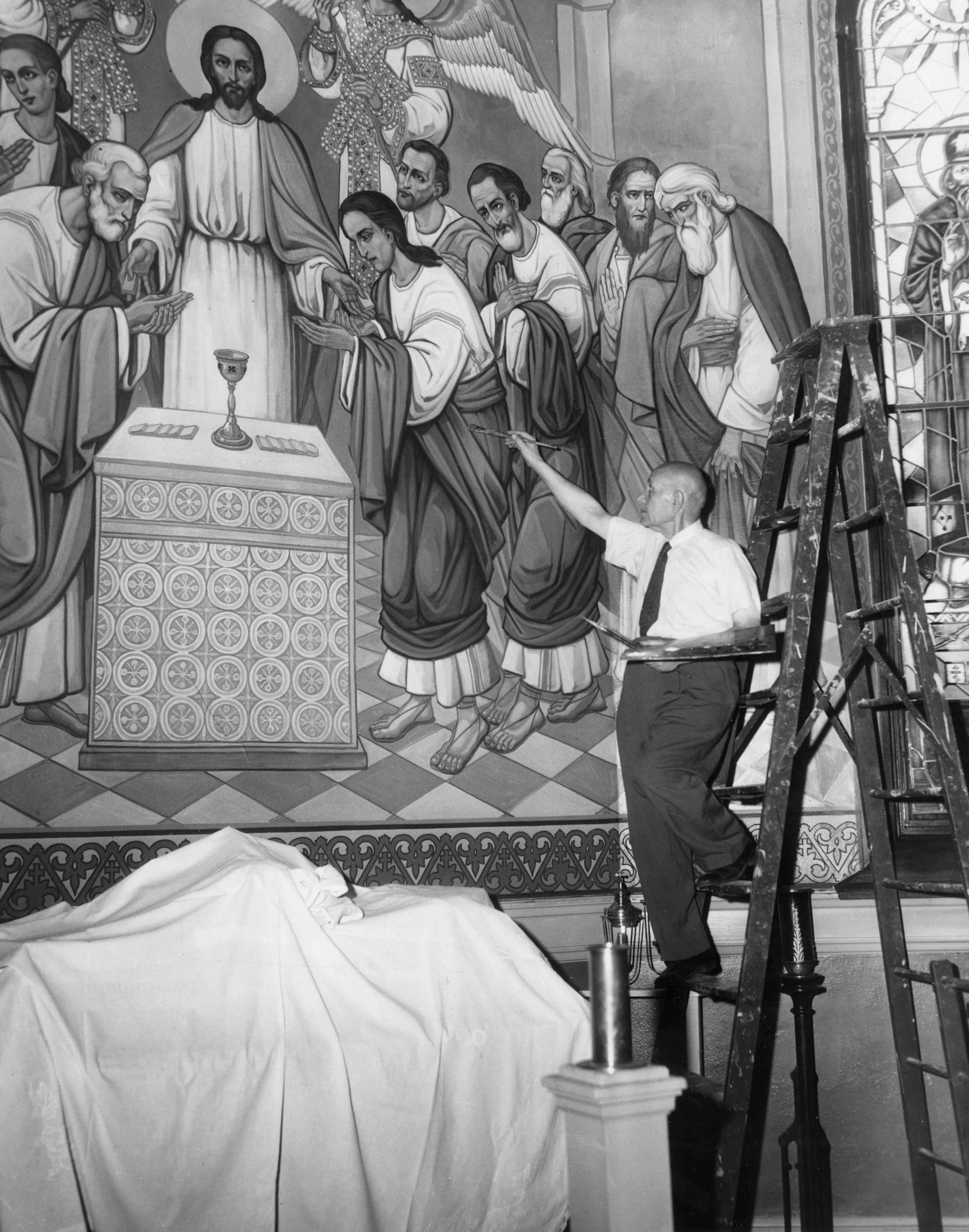 Russian émigré artist Andrei Bicenko puts the finishing touches on the altar fresco at St. Theodosius, 1954.  