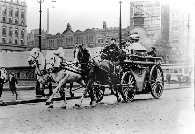 A three-horse team pulls the Cleveland Fire Department
