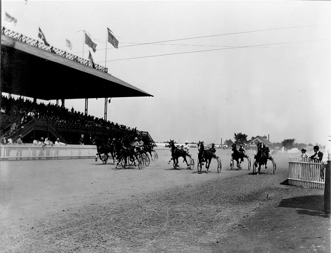 A full grandstand of spectators watch harness racing at Glenville Track, ca. 1900. WRHS.