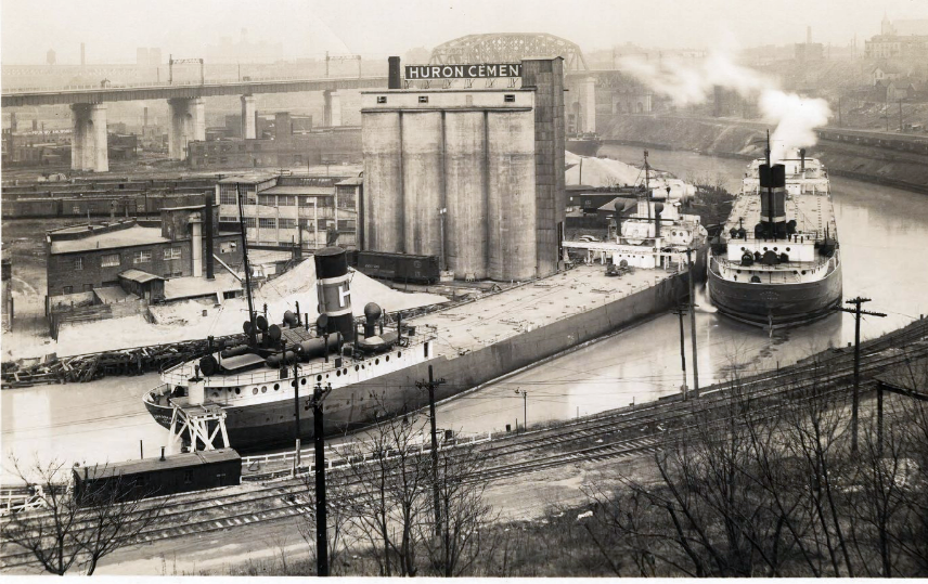 Exterior view, barges passing on Cuyahoga River near Huron Cement