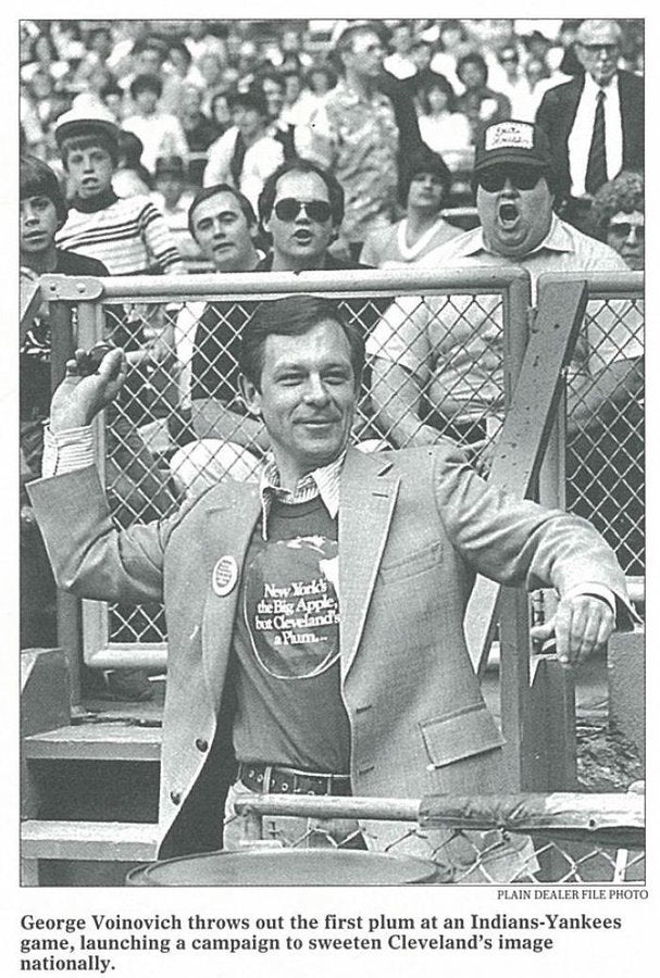 Photo caption reads “George Voinovich throws out the first plum at an Indians-Yankees game, launching a campaign [Cleveland is a Plum] to sweeten Cleveland’s image nationally.” Courtesy of The Plain Dealer.