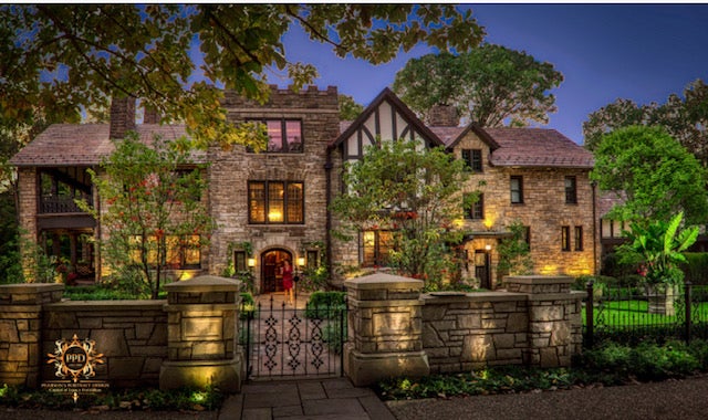 Harcourt Manor, currently the home of John and Anya Rudd, with its lights on.