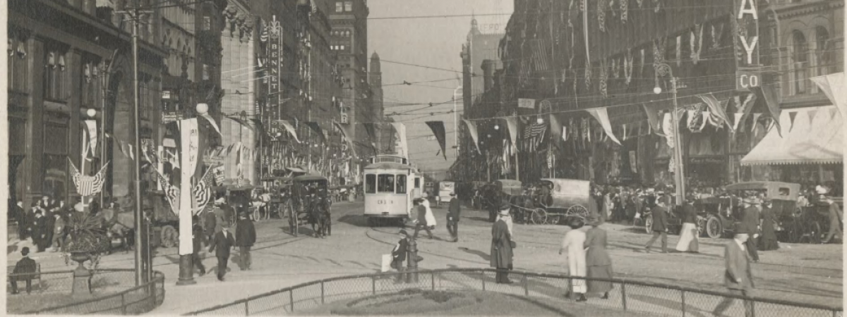 Looking east from S.E. corner of square;centennial celebration. Filled with horse and carriages, trolley cars and automobiles