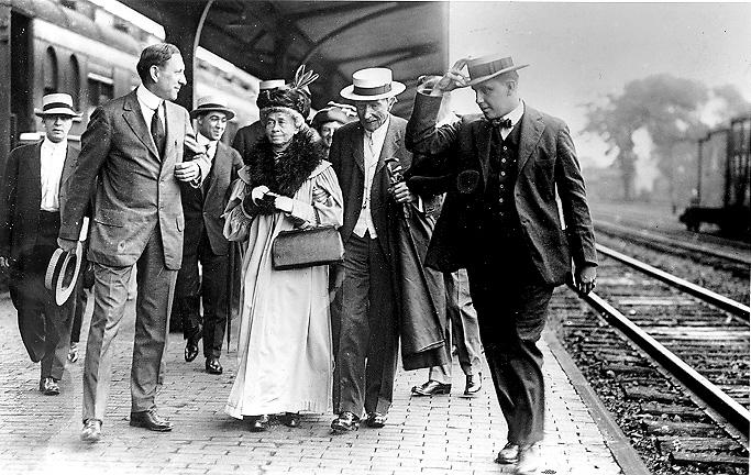 Standard Oil Co. founder John D. Rockefeller escorts sister-in-law Lucy Spelman through Coit Rd. Railroad Station in East Cleveland, en route to Rockefeller