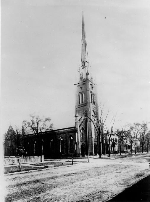 The tall spire of the Euclid Ave. Baptist Church dwarfs other buildings along Euclid near East 18th Street, ca. 1900. WRHS
