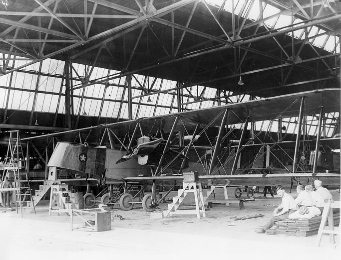 Workers at the Glenn L. Martin company  relax in front of the Martin MB-I Bomber they are building , ca. 1920. WRHS.