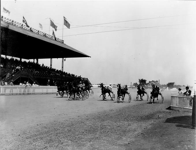 A full grandstand of spectators watch harness racing at Glenville Track, ca. 1900. WRHS.
