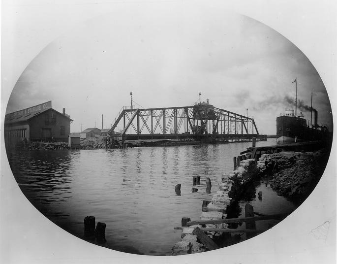 An early predecessor of the Main Ave. (Harold H. Burton Memorial) Bridge was this 200-foot hand-operated swing bridge, completed in 1869. WRHS.