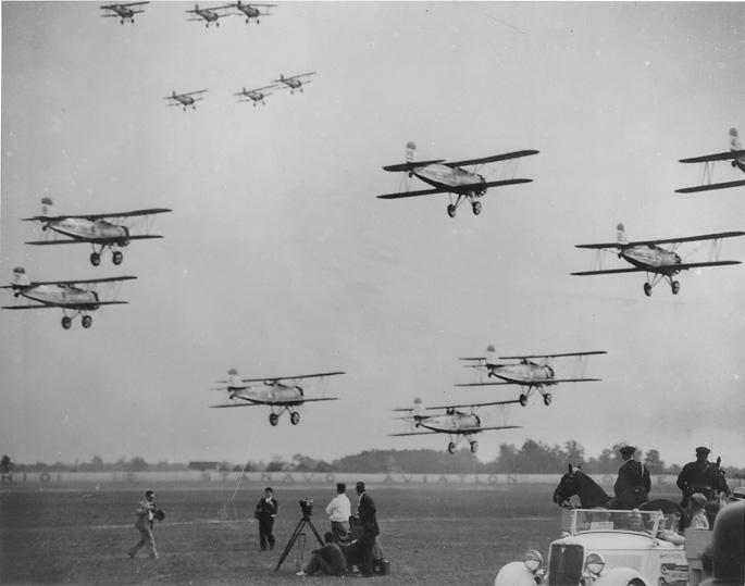 Multiple aircraft fly in formation at the National Air Races held in Cleveland, July 1935. WRHS.