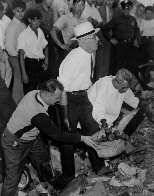 County Coroner Samuel Gerber and Cleveland Police detectives search among the rocks of the lakefront for remains of victims of the Torso Murderer, 1938. CPL.