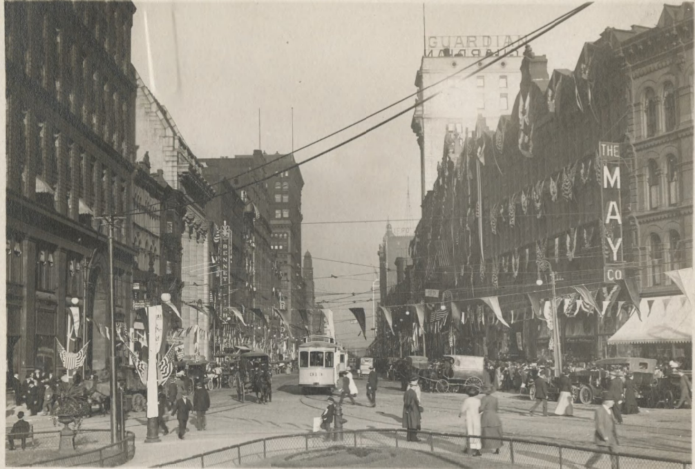Looking east from S.E. corner of square;centennial celebration. Filled with horse and carriages, trolley cars and automobiles