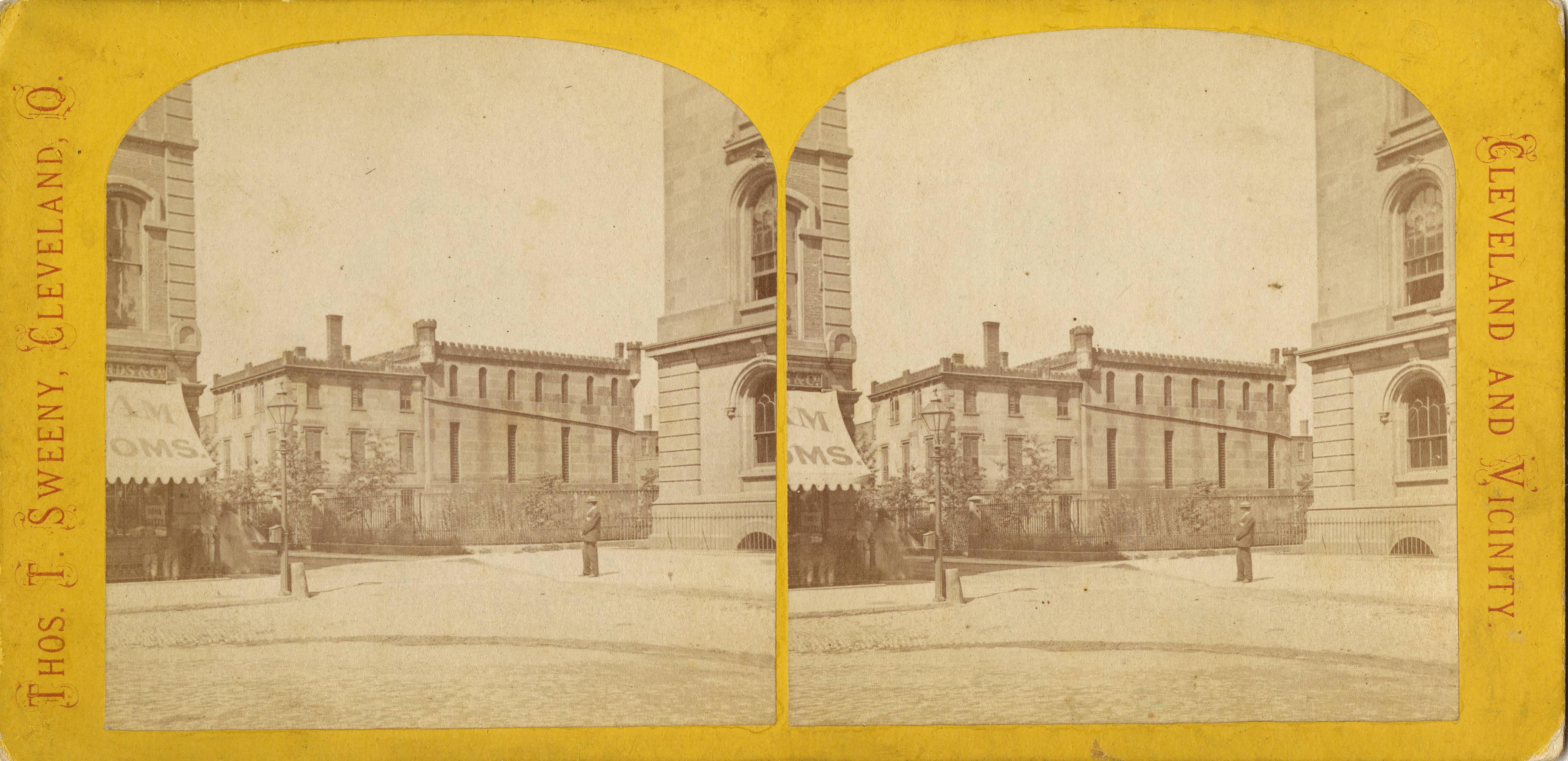 A stereograph of the third Cuyahoga County Jail, with a portion of the Court House visible at the right 