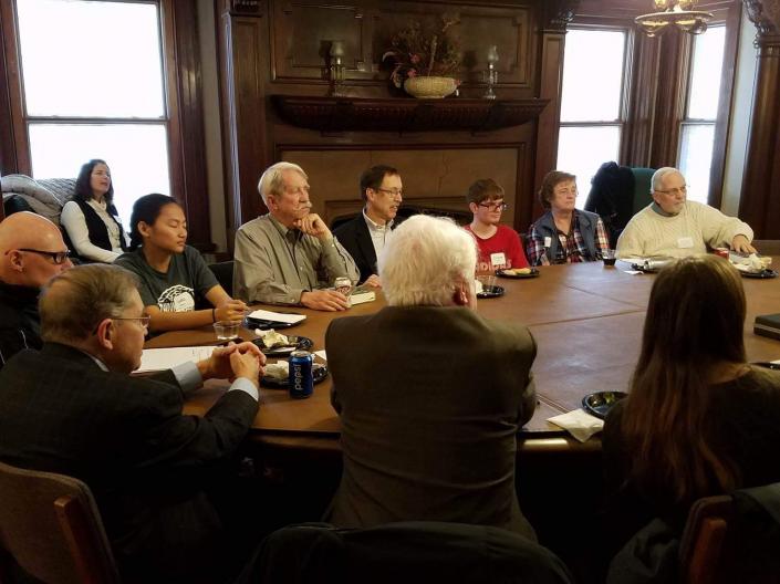 Emeriti academy members gathered around a table