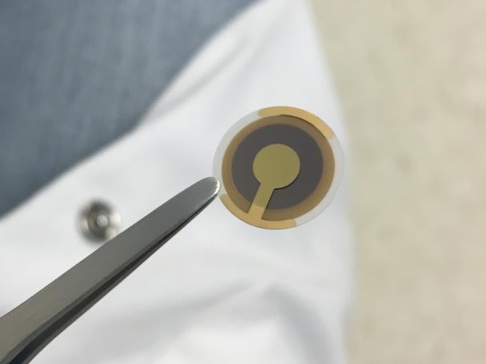 A picture of a sensors being held with a tweezers